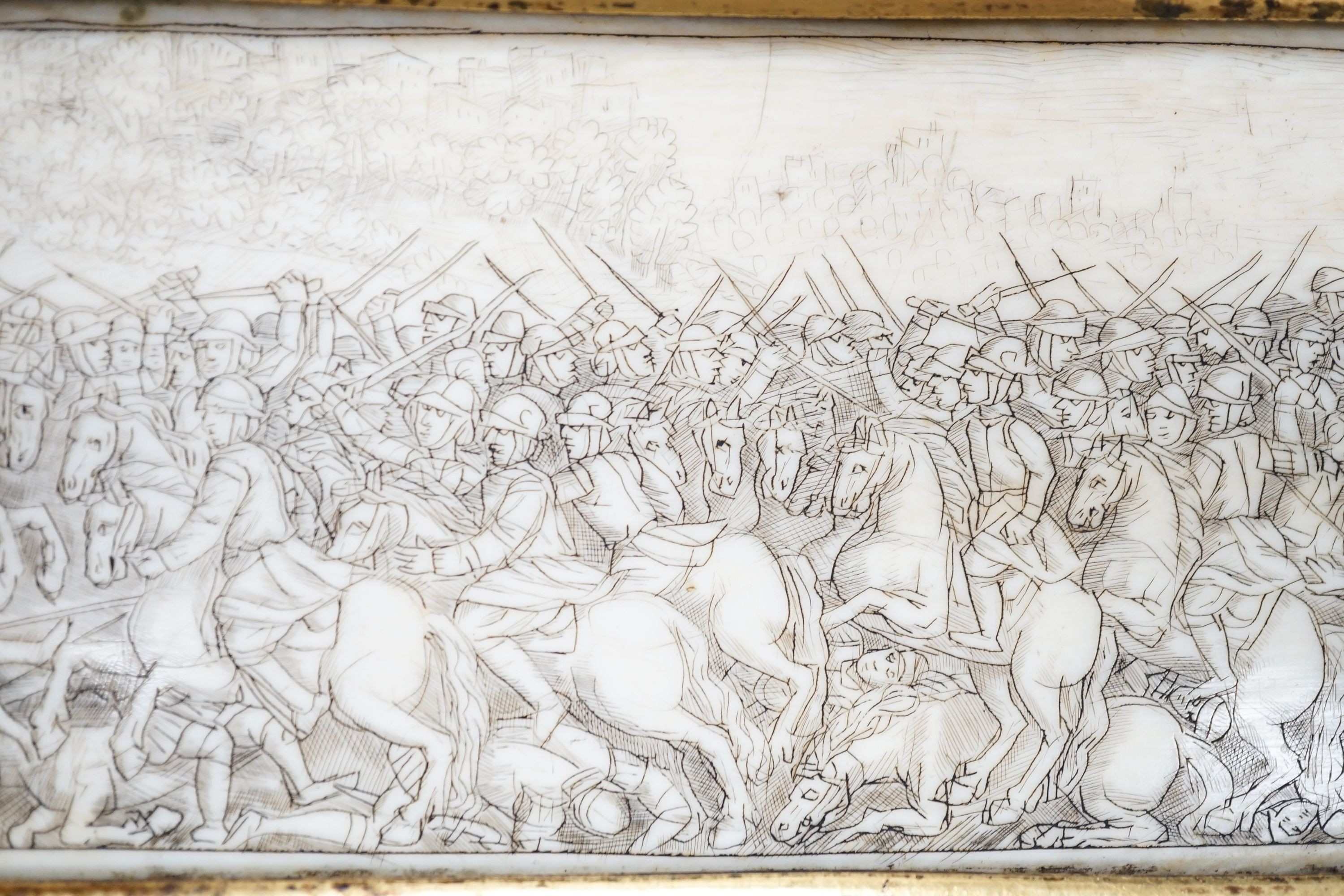 A 17th century French oval ivory plaque in a revolving metal surround, etched on both sides with battle scenes and ships in the background 17cm